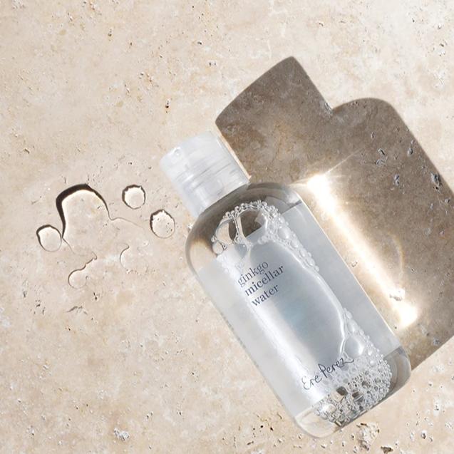 Bottle of Ere Perez Gingko Micellar Water laying on the ground in the Sun