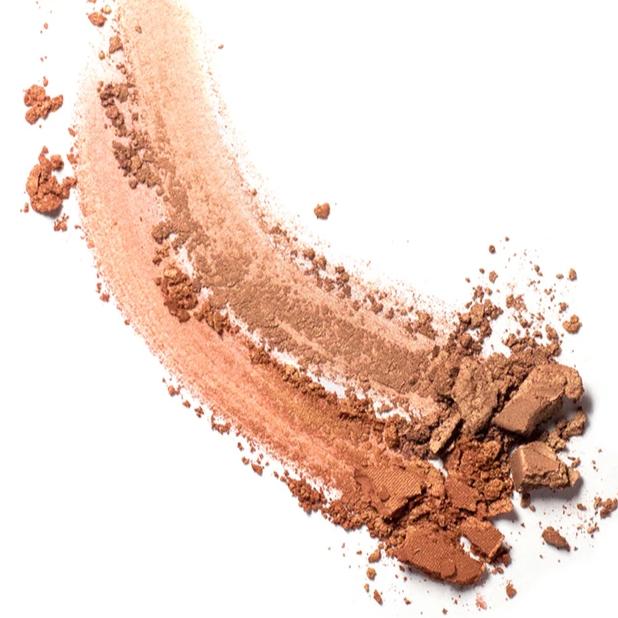Two smears of Ere Perez Rice Powder Bronzer on surface